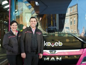 zwei Busfahrer der koveb vor koveb-Bus Busfahrerin und Busfahrer der koveb lehnen lässig an einem koveb-Bus